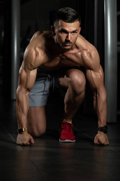 istock Strong Muscular Men Kneeling On The Floor 1196353471