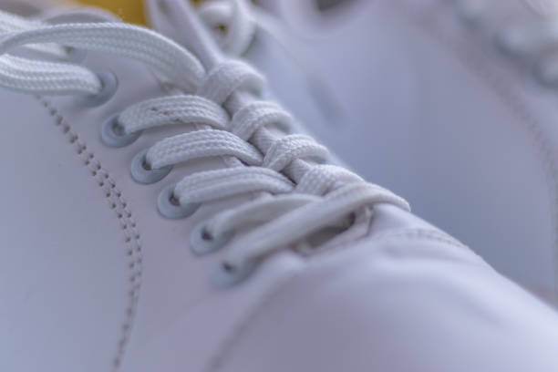 istock White sneakers on light colour background, flat lay top view minimal background. 1196354314