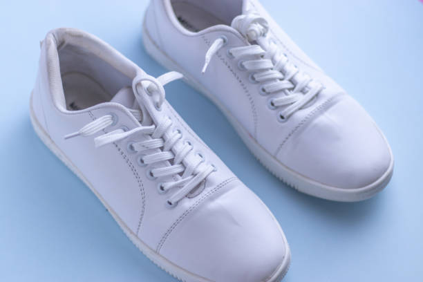 istock White sneakers on light colour background, flat lay top view minimal background. 1196354357