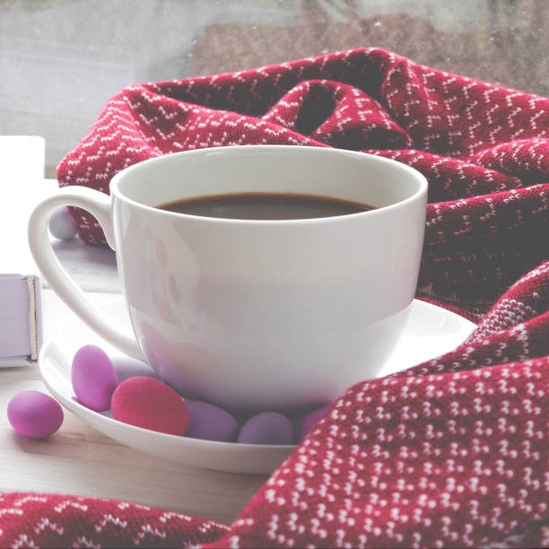istock coffee, a book and a blanket in the rain 1196358239