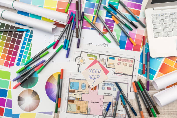 istock Colour palettes with house plan on desk top view. Designer working at new project 1196365133