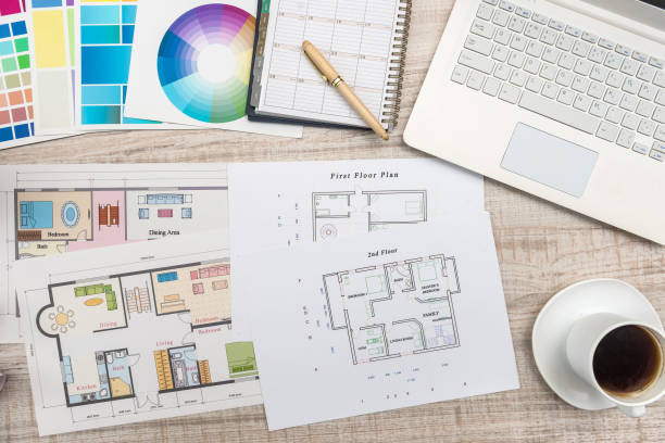 close up view of color palette swatch and house building plans on office desk with laptop and cup of coffee for break - home decorating fabric swatch color swatch blueprint imagens e fotografias de stock