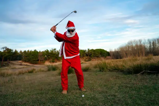 Santa Claus practicing his golf swing