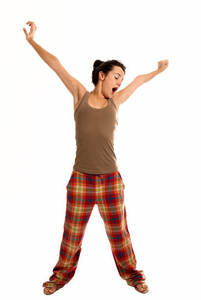 young woman be sleepy wearing pajamas isolated on white background stock photo