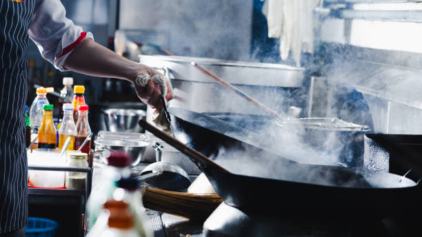 istock Chef stir fry in wok 1196372366
