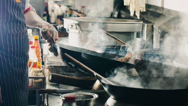 istock Chef stir fry in wok 1196372422