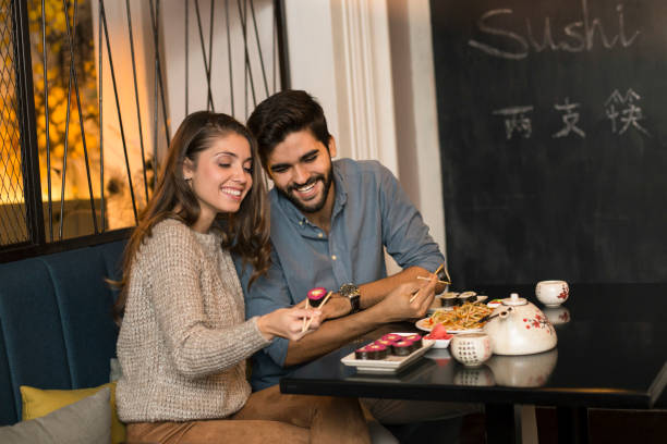 istock Smiling couple having a meal 1196373180