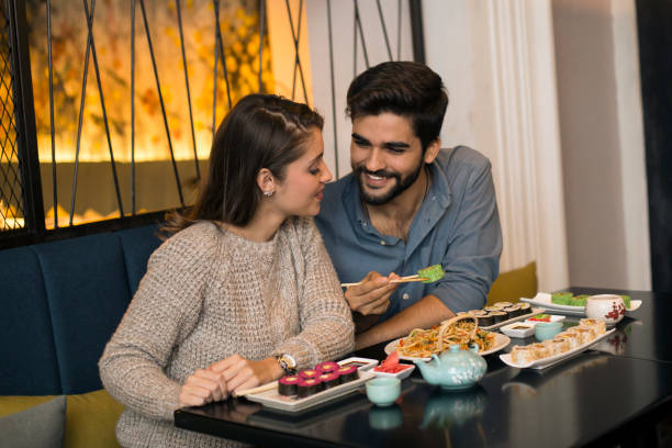 istock Couple eating Japanese food 1196373205