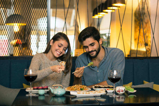 istock Couple eating sushi 1196373235