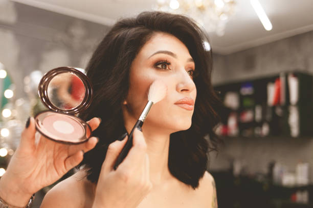istock Makeup artist makes blush with a brush 1196374210