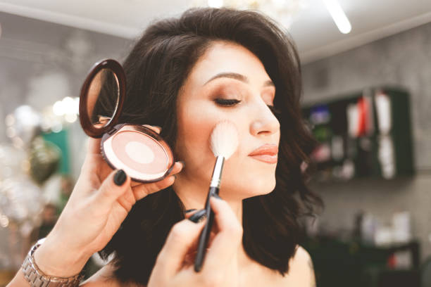 istock Makeup artist makes blush with a brush 1196374237