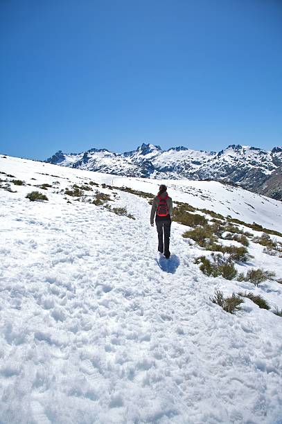 istock lonely woman trekking on snow 119637451
