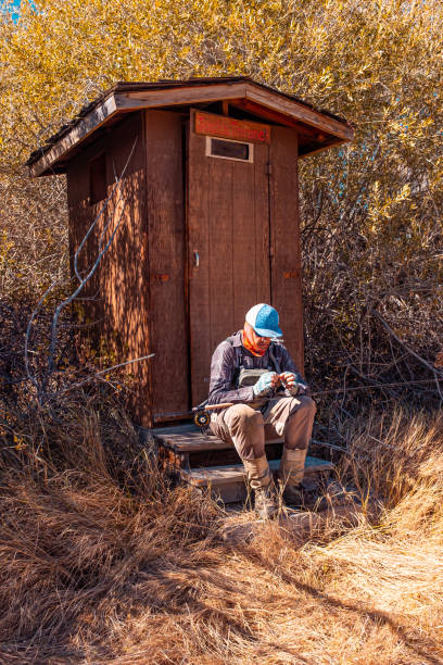 istock Fly Fisherman Using The Outhouse 1196374956