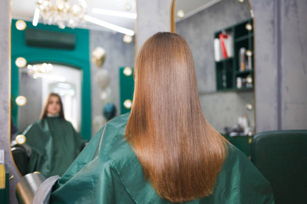блестящие и прямые волосы молодой девушки после процедуры ламинирования волос. кератин и ботокс волосы - плавный стоковые фото и изображения