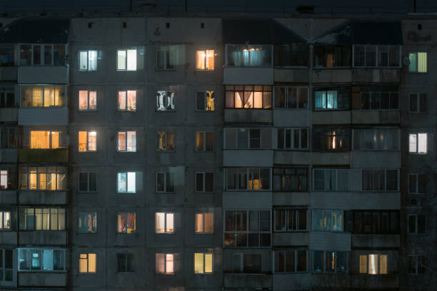 istock Facade of building at night light in the windows 1196375906