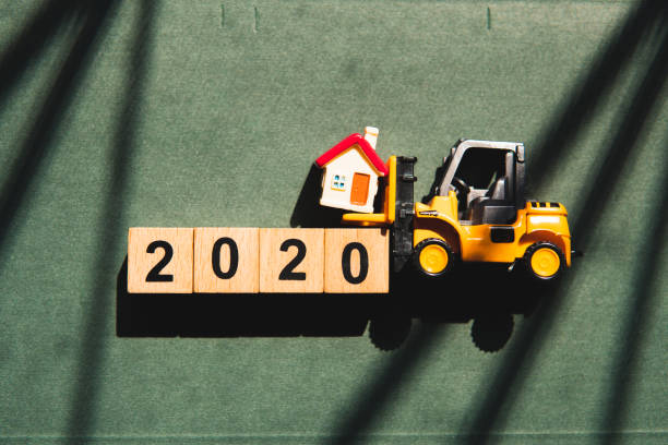 istock Miniature forklift lift up mini house 1196376997