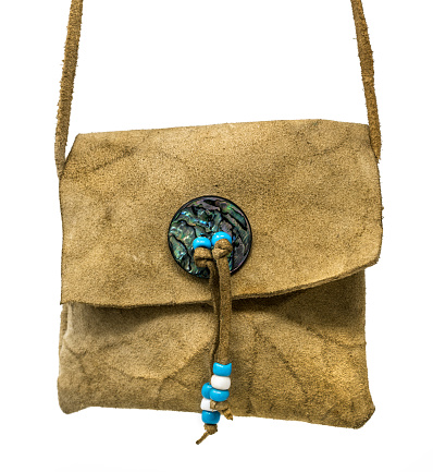 Bag of the North American Indians. Made from deerskin embroidered with colorful glass beads and leather cords isolated on white