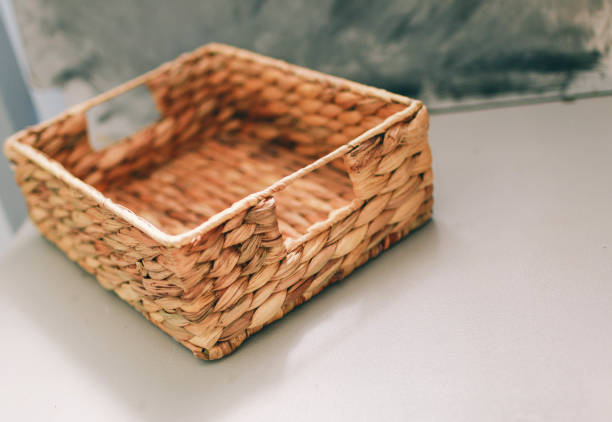 istock wicker basket lies on a gray background 1196377415