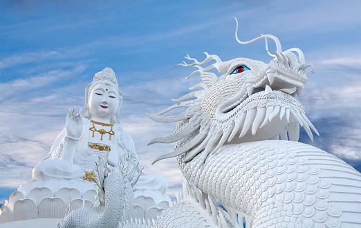 Guan Yin Goddess and Dragon - exterior of Wat Huay Pla Kang, Big Buddha temple at sunset in Chiang Rai, Northern Thailand