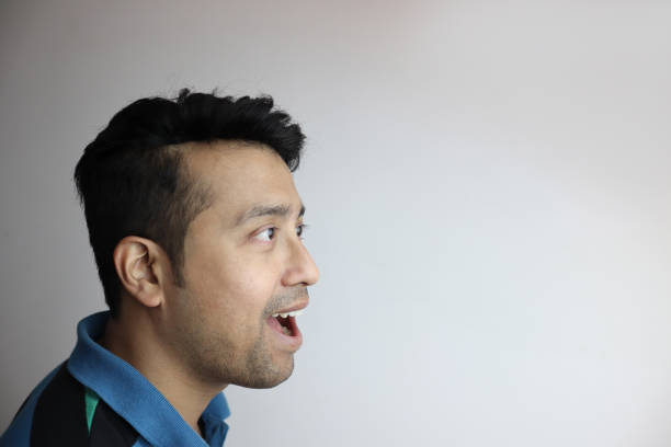 istock omg. right side face of an asian man with amazed expression looking towards a copy space with white background. 1196379299