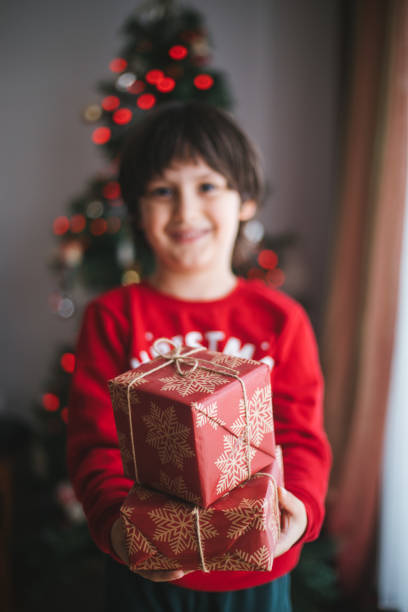 istock Young Boy Smiles with his Christmas Present 1196380271