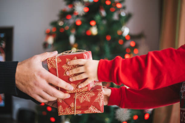 istock Hands giving christmas gifts 1196380863
