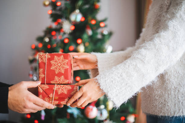 istock Hands giving christmas gifts 1196380864