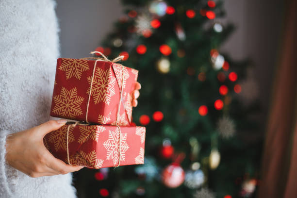 istock Woman holding christmas gift 1196381059