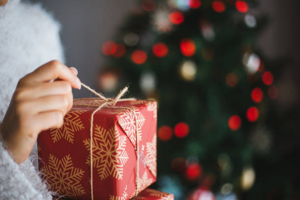 istock Woman holding christmas gift 1196381066