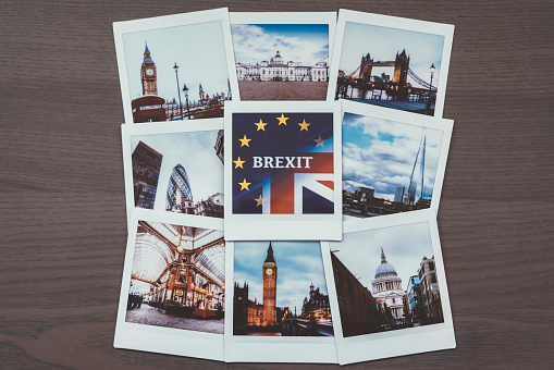 Close-up of instant photos from London on dark background.Brexit concept