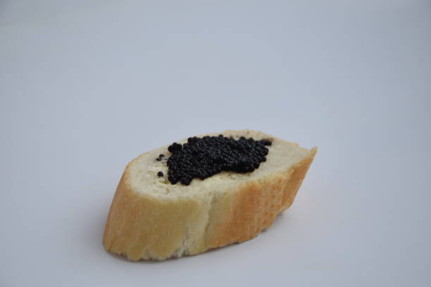istock one sandwich with black caviar isolated on the white background 1196383169