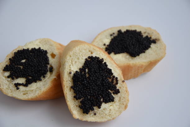istock Three sandwiches with black caviar isolated on the white background 1196383188