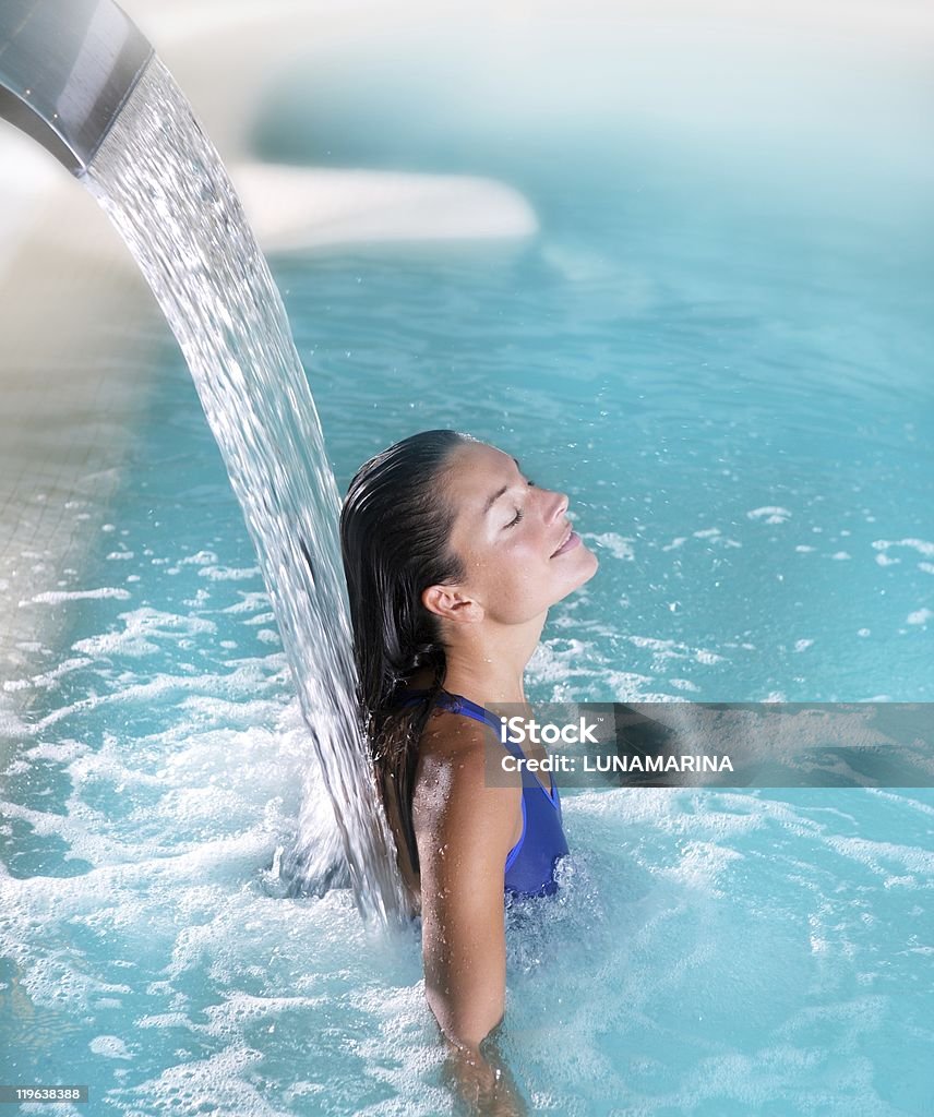 spa hydrotherapy woman waterfall jet  Spa Treatment Stock Photo