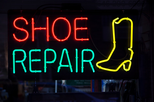 New York City, New York, USA -November 11, 2015: Colorful shoe repair shop neon sign.