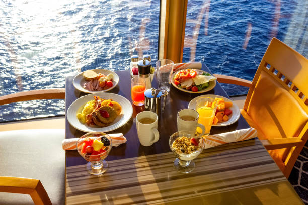 Dining Room Buffet aboard the luxury abstract cruise ship Dining Room Buffet aboard the abstract luxury cruise ship. breakfast with sea view exclusive dinner stock pictures, royalty-free photos & images