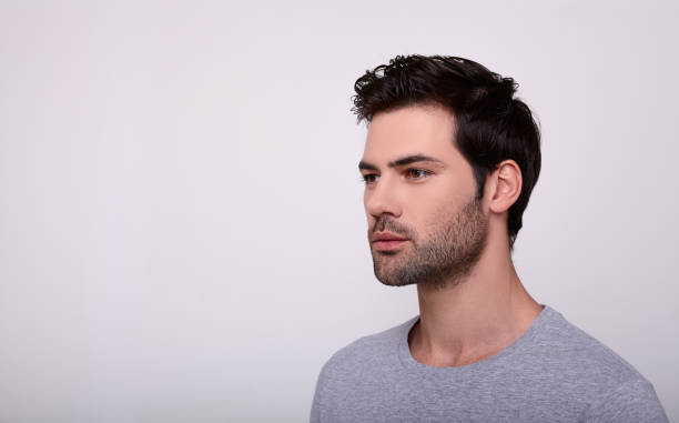 istock Confident man with dark hair looks away. 1196385292