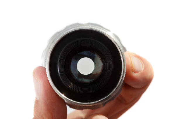 istock Hand holding camera lens on white background 1196385416