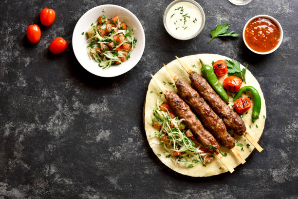 istock Turkish Adana Kebab with fresh vegetables on flatbread 1196388319