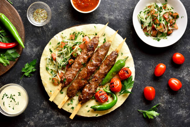 istock Turkish Adana Kebab with fresh vegetables on flatbread 1196388328