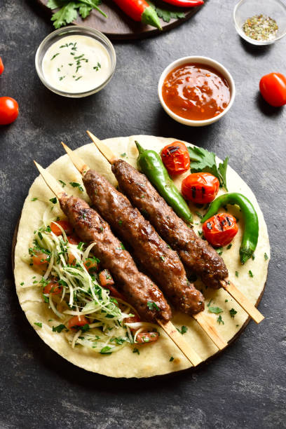 istock Turkish Adana Kebab with fresh vegetables on flatbread 1196388342