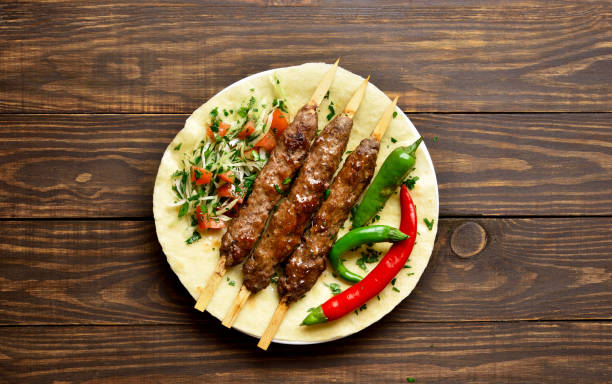 istock Turkish Adana Kebab with fresh vegetables on flatbread 1196388343
