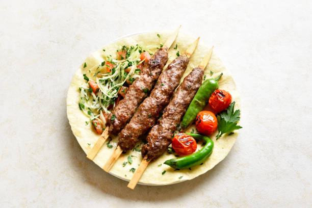 istock Turkish Adana Kebab with fresh vegetables on flatbread 1196388349