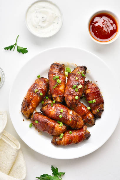 istock Bacon wrapped grilled chicken wings 1196388598