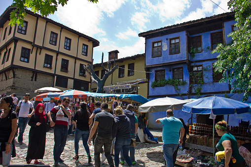 Bursa, Turkey - May 14, 2017: Vendors selling homemade bread and conserved foods at farmer's market in cumalikizik village in bursa, Turkey. Cumalikizik is an old ottoman village. There are lots of people on the street for visiting the village.