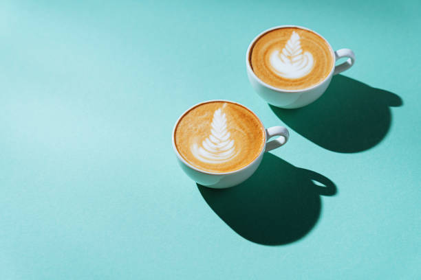 istock two Cup of coffee on color background. 1196391224