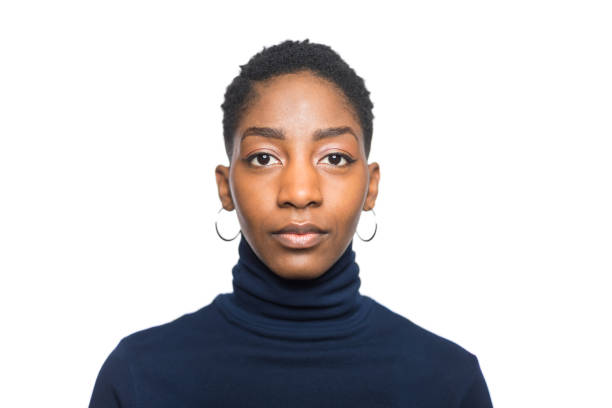 Portrait of african woman Portrait of young afro woman looking at camera. Shot of african female in casuals against white background. turtleneck photos stock pictures, royalty-free photos & images