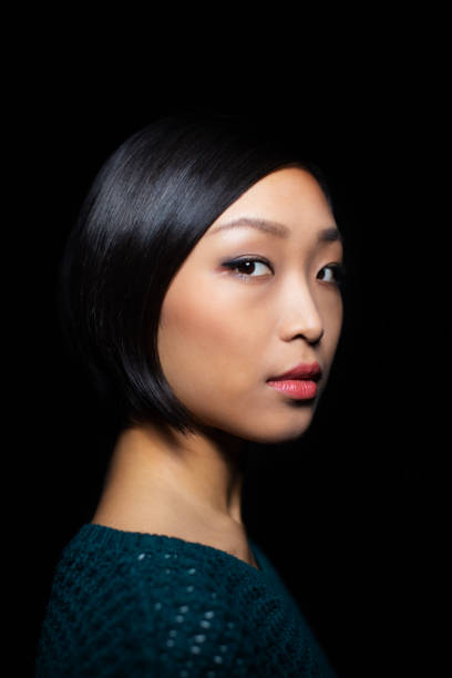 istock Confident young asian woman staring at camera 1196391542