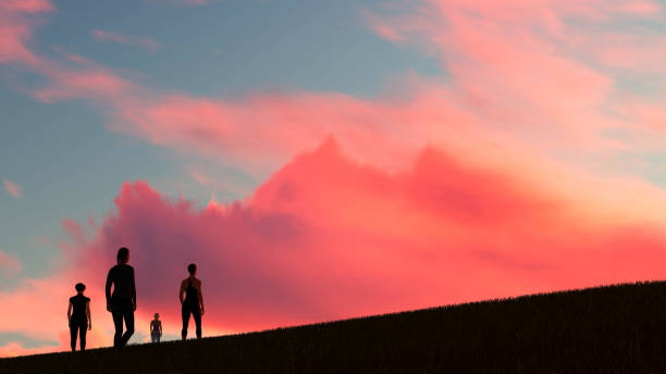 Silhouetted couple watching sunset, summer solstice, Nairn, Scottish Highlands