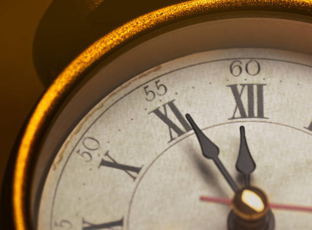 istock Golden vintage alarm clock showing five to twelve 1196400505