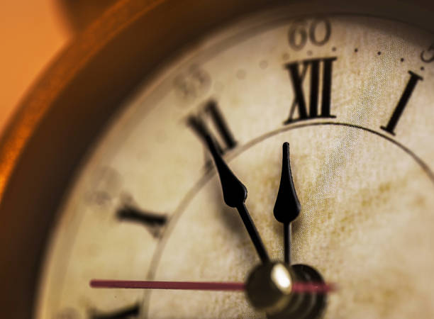 istock Golden vintage alarm clock showing five to twelve 1196400524